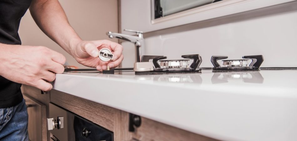 a man checking his gas stove
