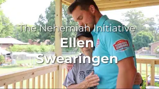 Kelton Balka in a blue polo shirt hugs an older woman on a wooden porch. Text reads: “The Nehemiah Initiative, Ellen Swearingen.”.