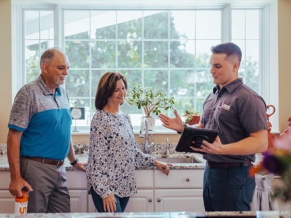couple having a conversation with the plumber of Tennessee Standard Plumbing