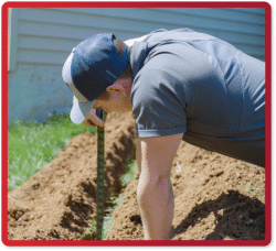 man digging for water lines