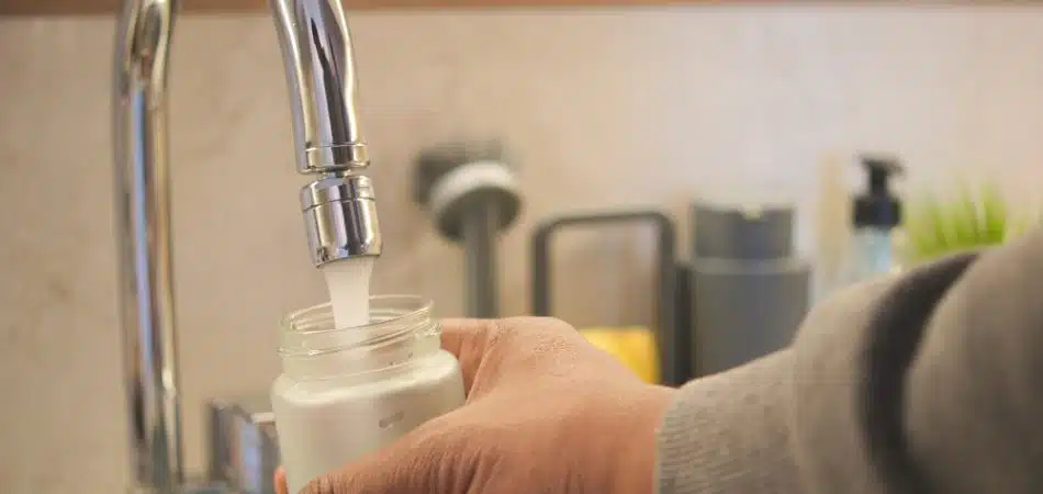 Filling a bottle with water from a faucet using hand gestures,