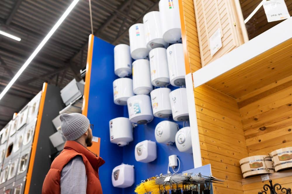 guy looking at different water heater in a store