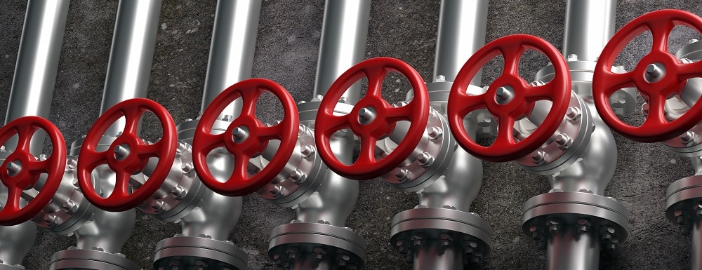 Oil and gas industry. Pipelines and valves with red wheels system on gray wall