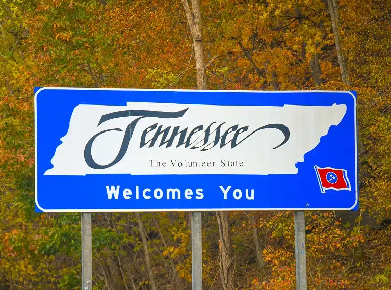 A blue roadside sign reading