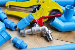 Plumbing tools and blue PVC pipes