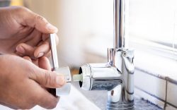 Plumber man, tap and hands of maintenance for installation, home renovation and builder service. Cl.