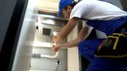 plumber repairing clogged drain