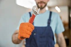 plumbers holding wrench