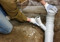 Installation of PVC sewer lines showing common pipe materials used in homes.