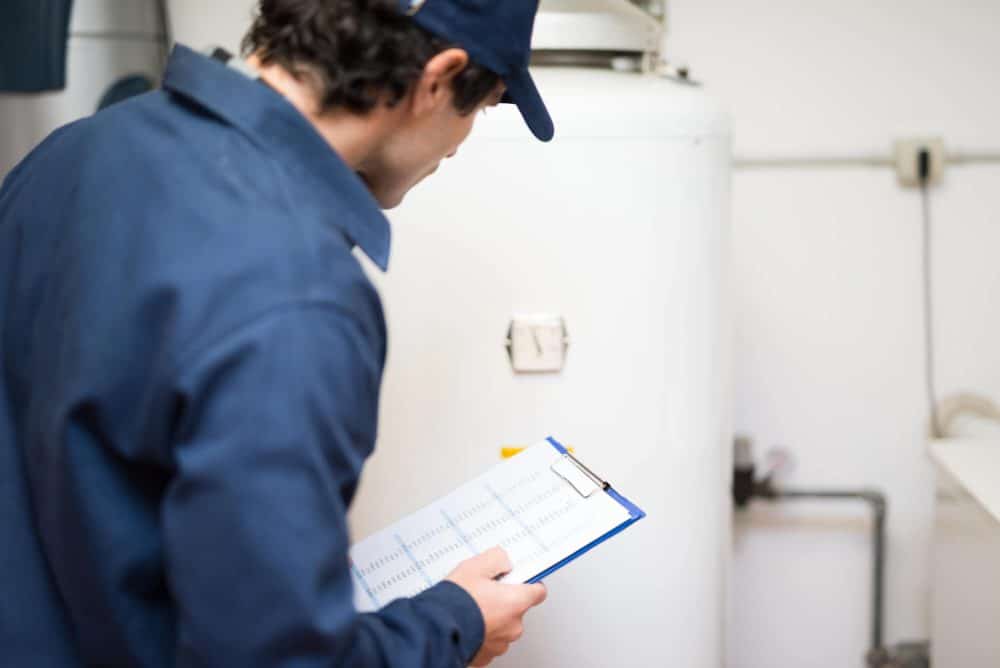 worker doing water heater inspection